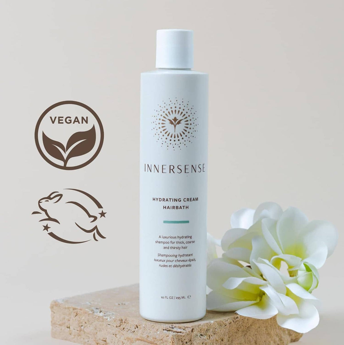 Hydrating Cream Hairbath bottle with vegan icon and white flower accents