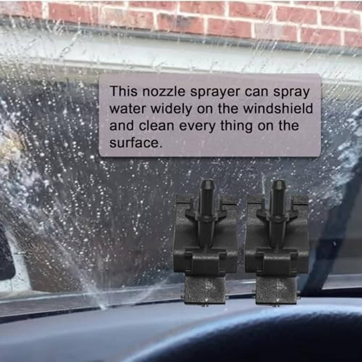 Windshield washer nozzles installed on windshield, two black jets spraying water