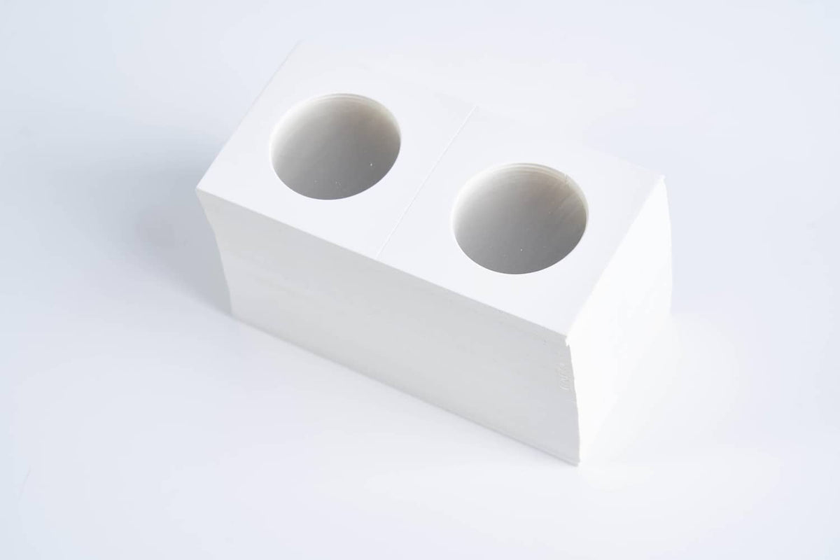 White cardboard coin holder with two oval openings