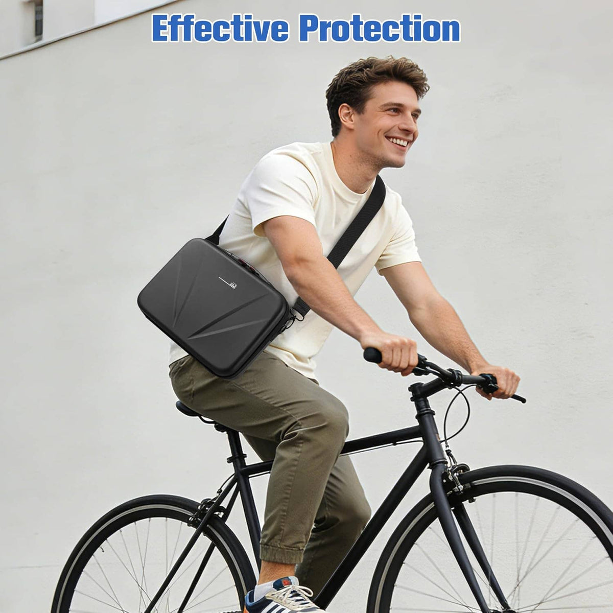 Black hard camera case with shoulder strap on cyclist while holding bike handlebars