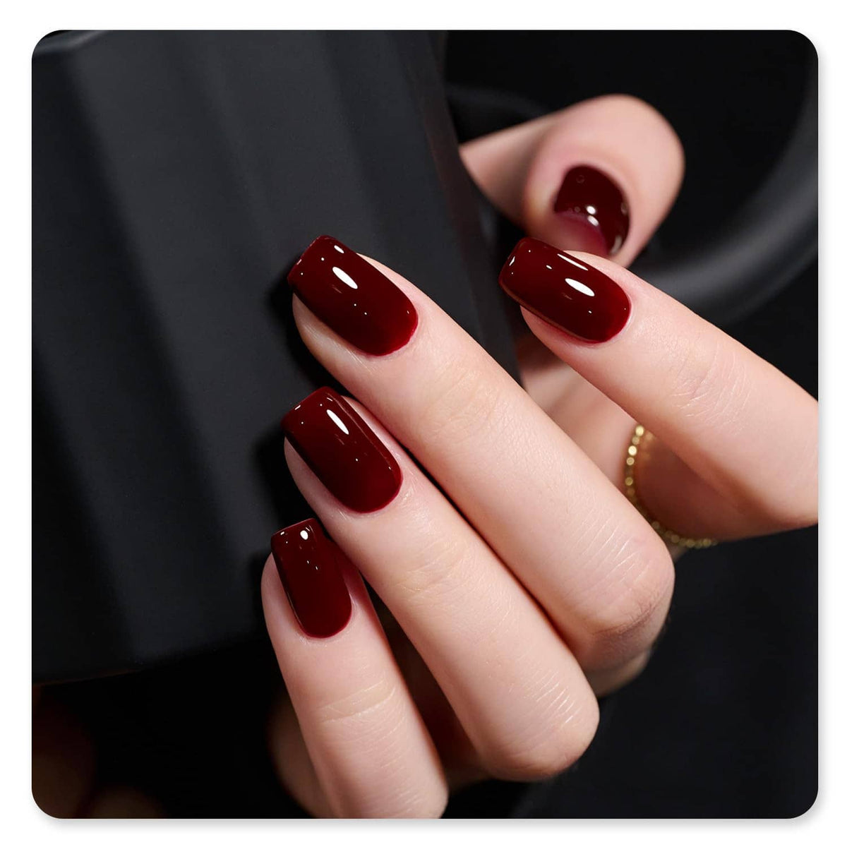 Dark red gel manicure on fingers with glossy nails; GAOY UV gel polish bottle.