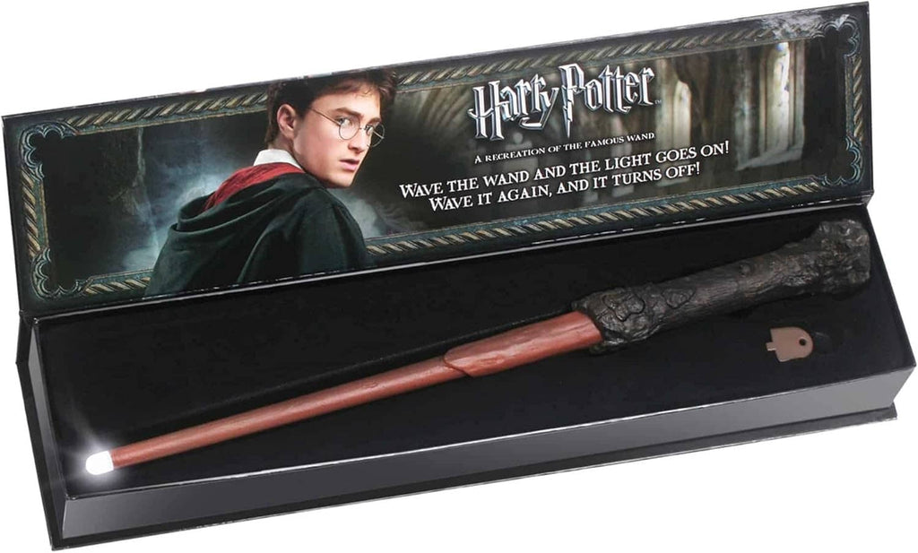 Illuminating wand in open gift box with Harry Potter graphics and lit tip