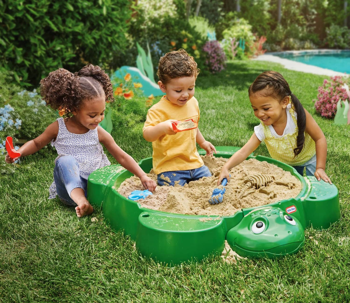 Green turtle-shaped sandbox with open bowl and turtle head front