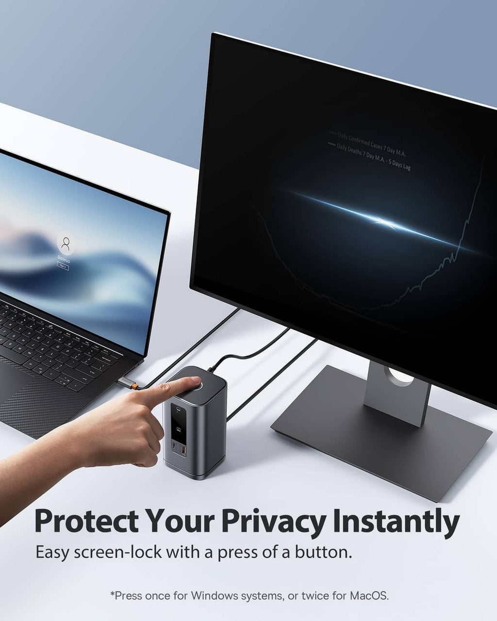 Space grey docking station with screen-lock button beside connected monitors