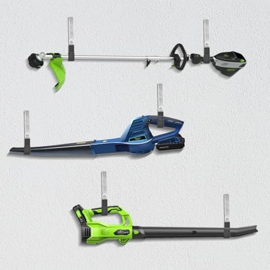 Metal wall hooks with black grips holding outdoor power tools