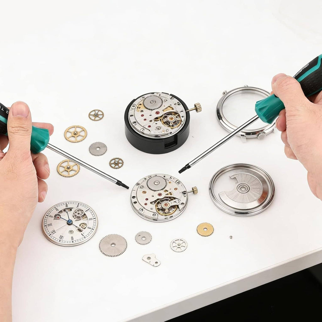 Teal-handled precision screwdriver working with small watch parts and metal gears