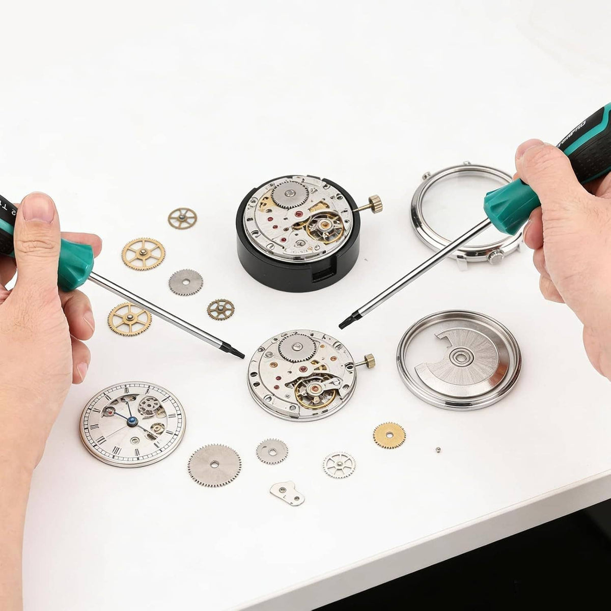 Teal-handled precision screwdriver working with small watch parts and metal gears