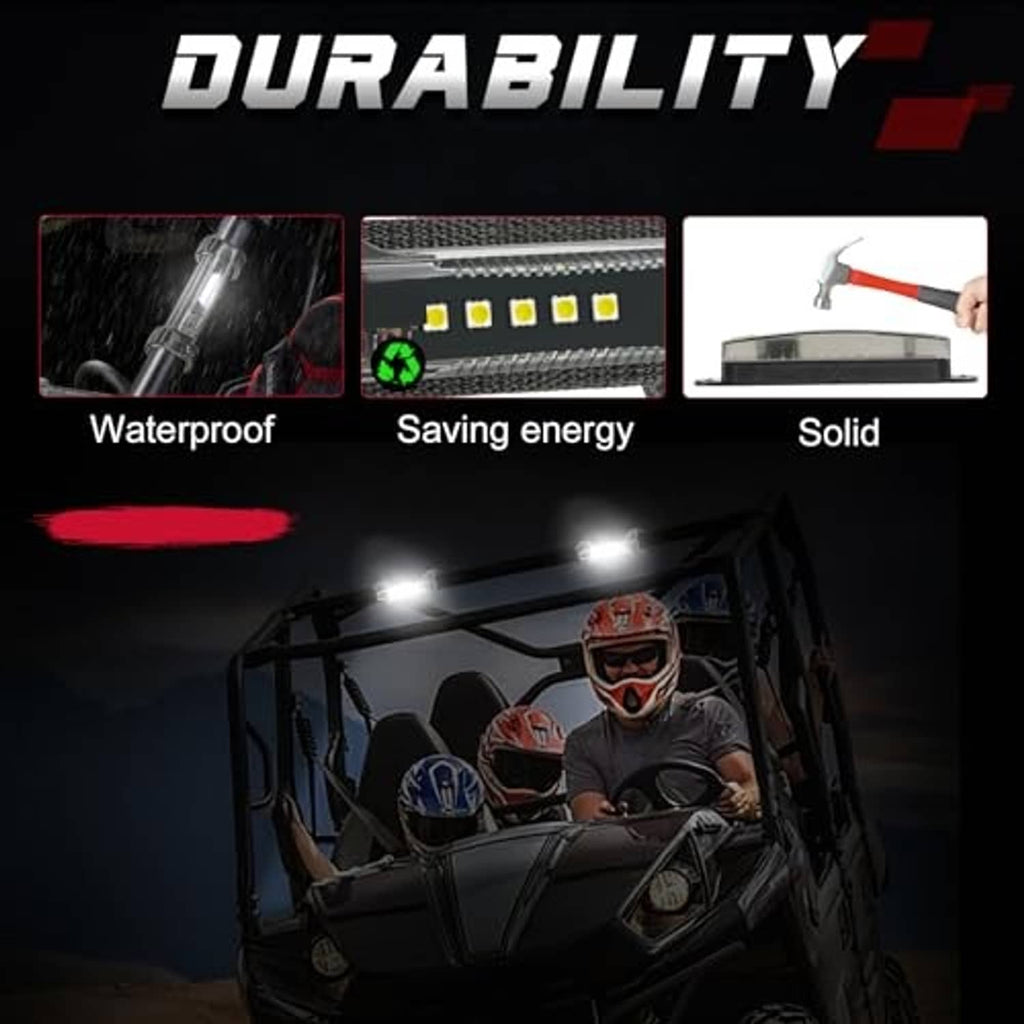 Smoked black LED dome light bar with bright white beams on a UTV roll cage