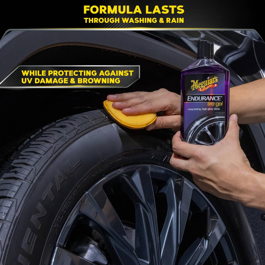 Hand wiping tire with sponge while holding Meguiar’s Endurance tire gel bottle