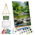 Landscape paint-by-number kit contents: easel, canvas, brushes, and paint pots