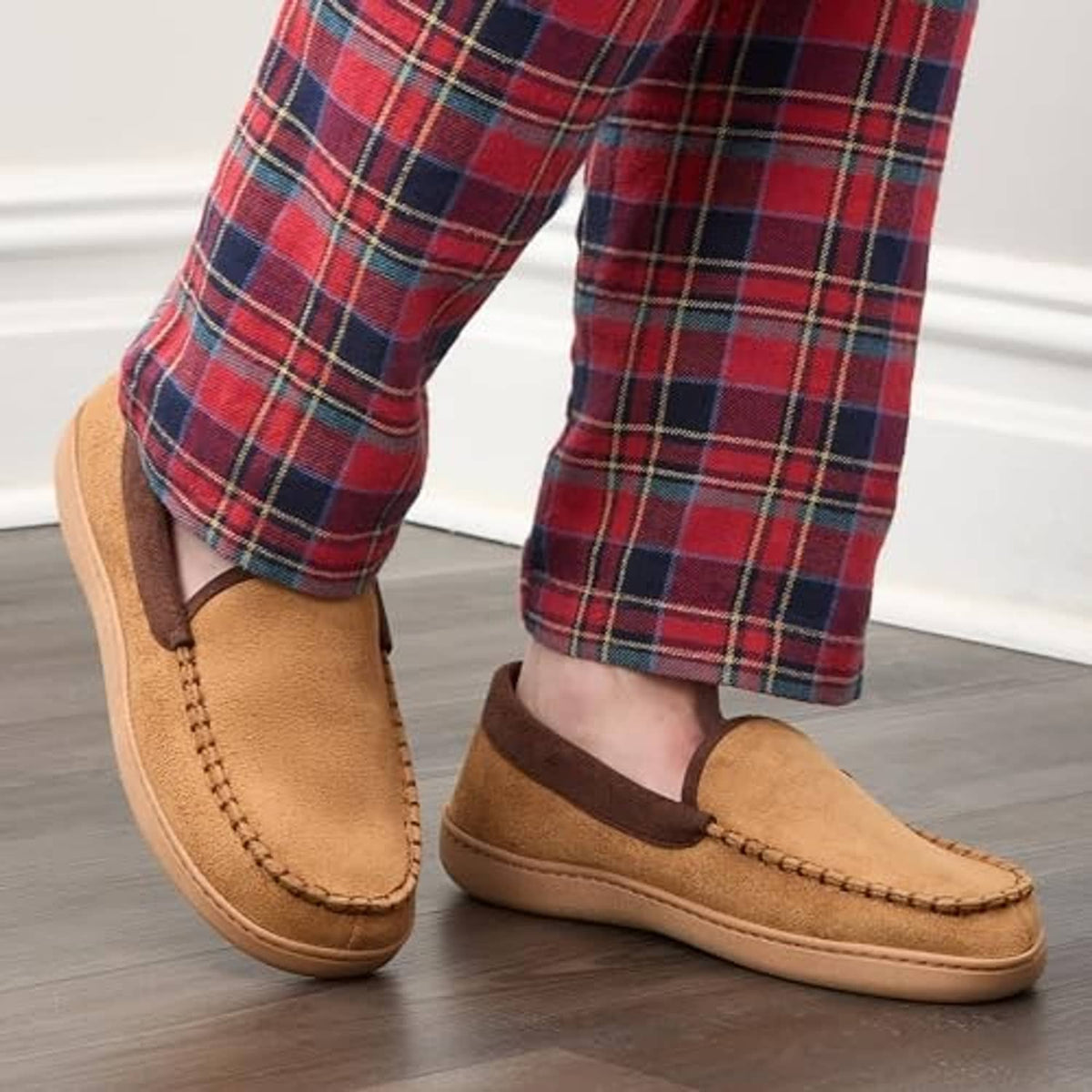 Tan slip-on slippers worn with plaid pajama pants; cushioned suede-like uppers