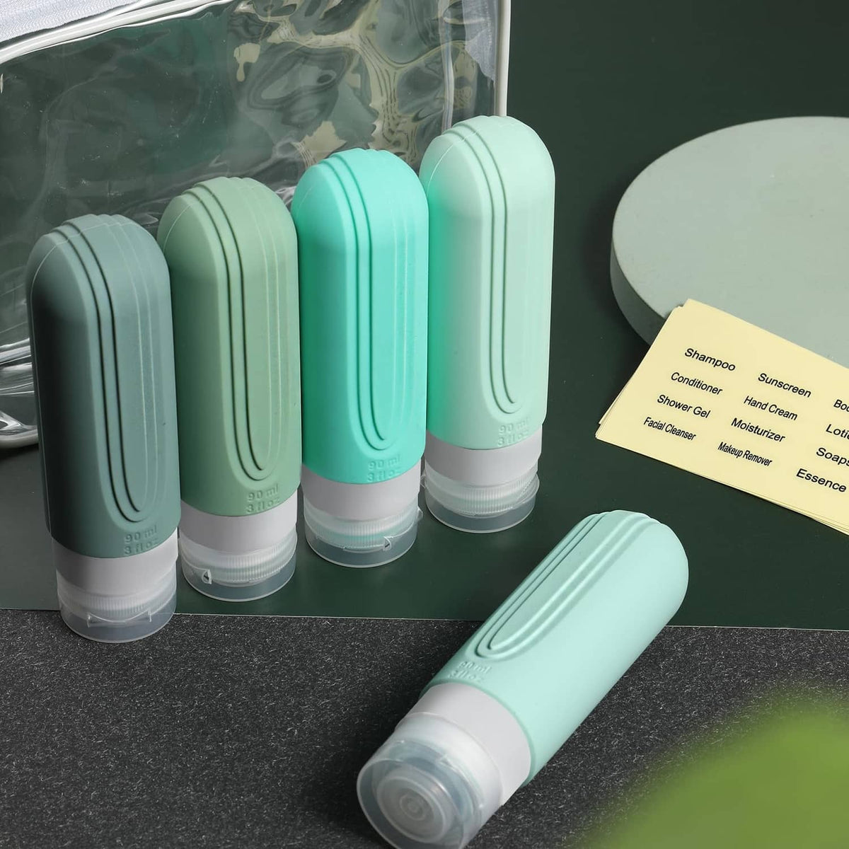 Mint green travel bottle set stored in a clear zip pouch with a labeling card