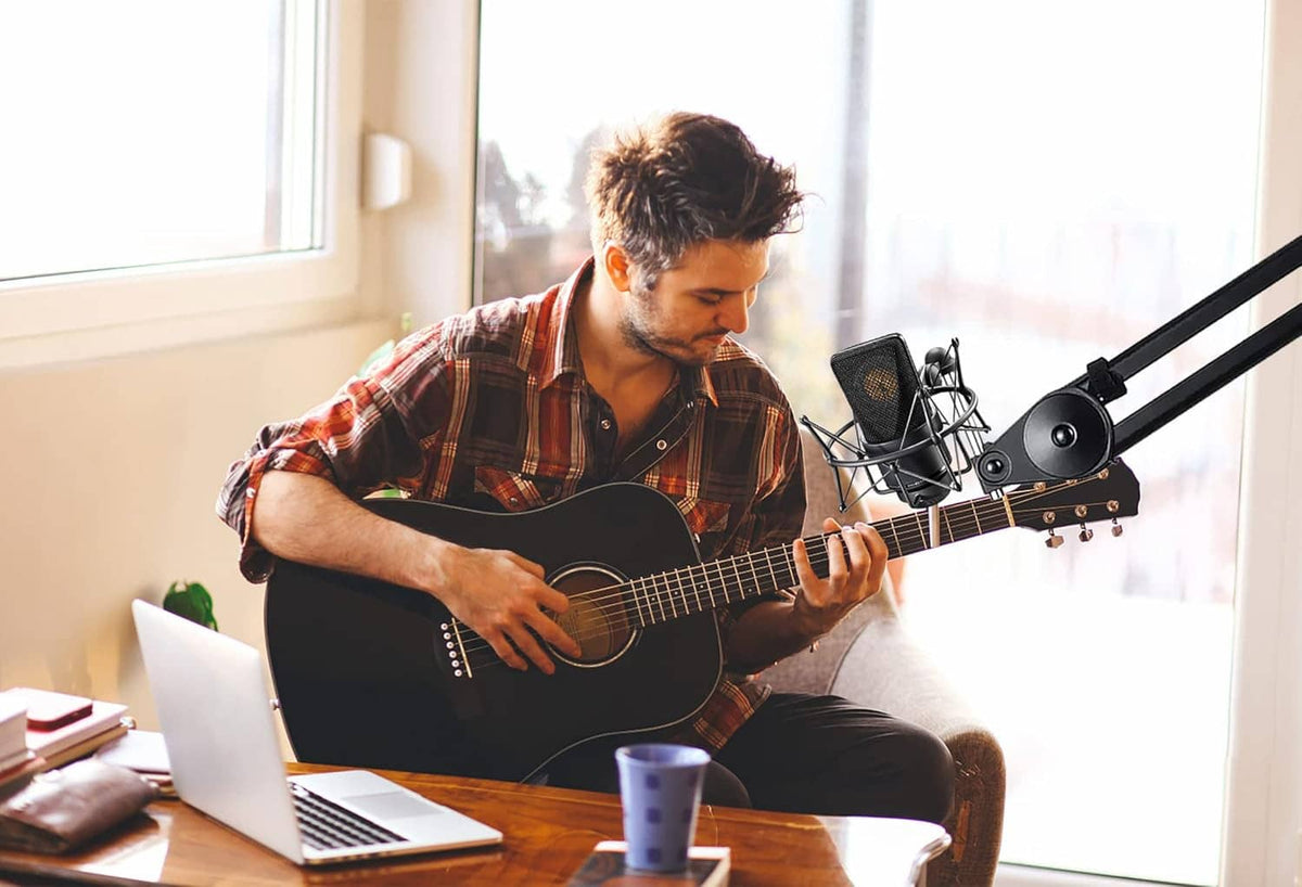 Microphone shock mount with condenser mic mounted beside guitar during recording