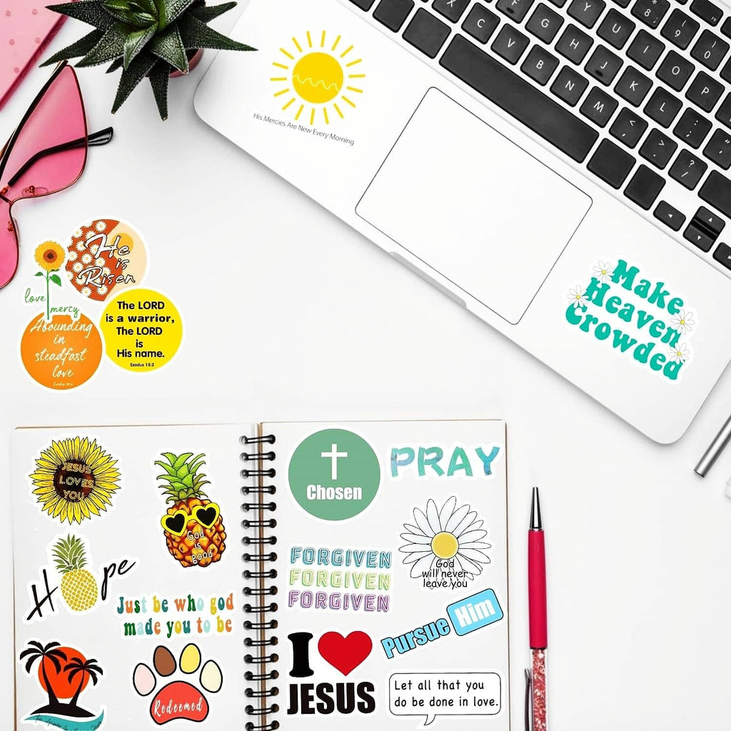 Christian quote sticker set on a notebook and near a laptop keyboard