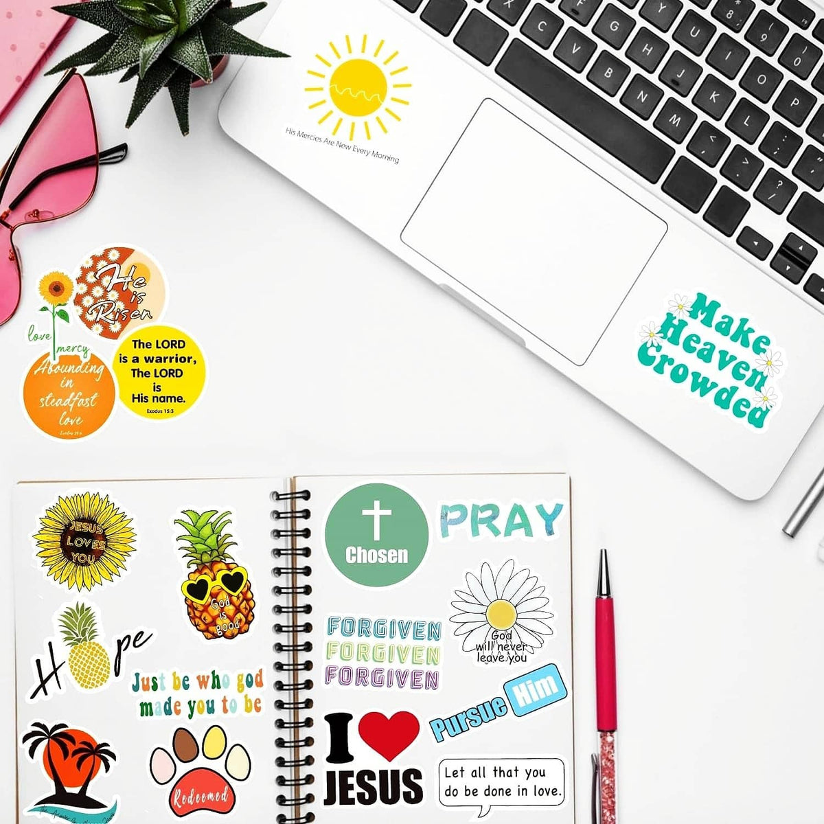 Christian quote sticker set on a notebook and near a laptop keyboard