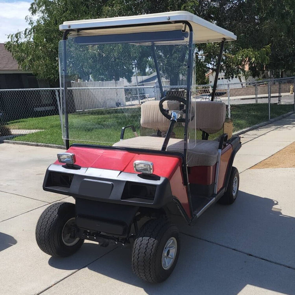 Golf cart front cowl panel with headlight openings installed on red vehicle