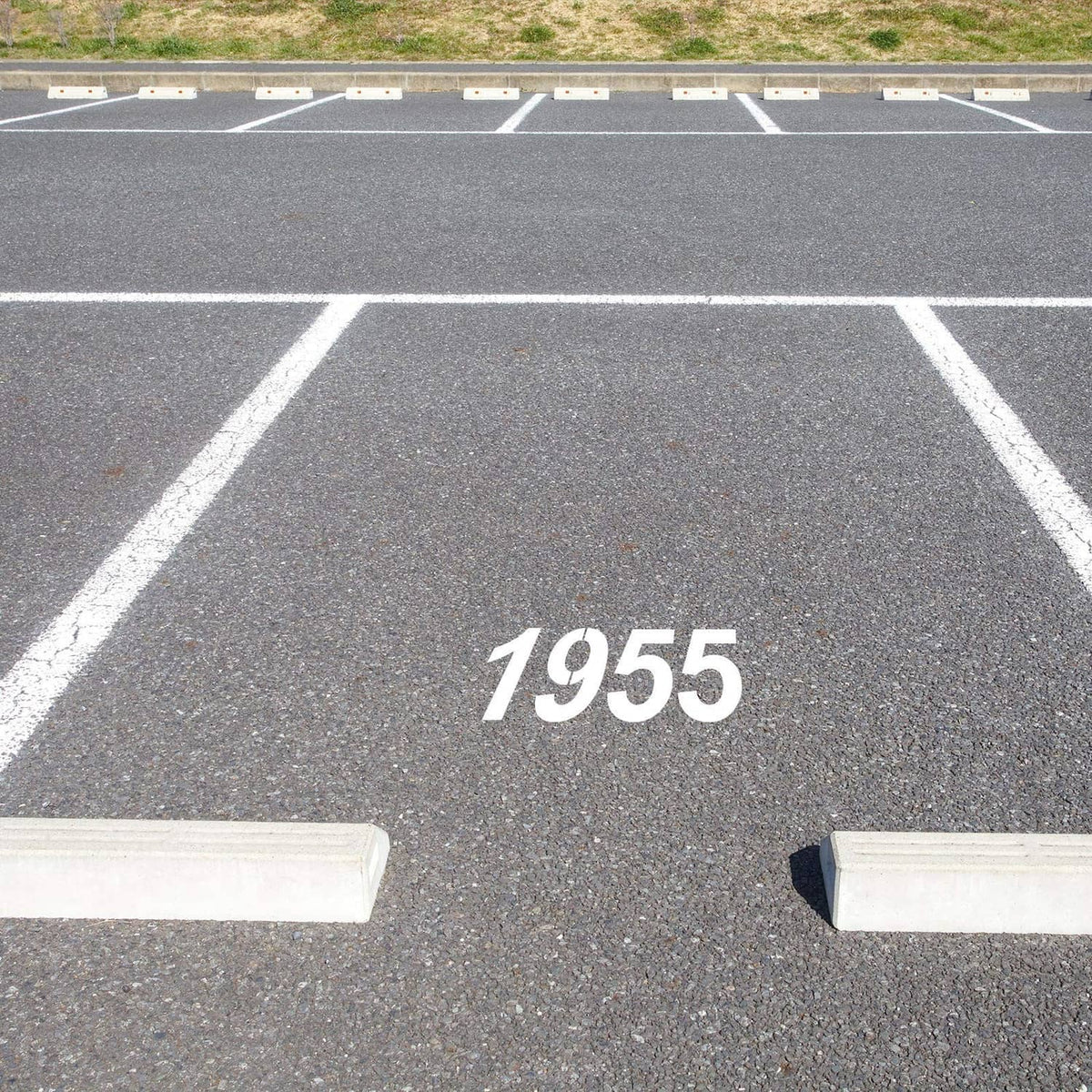 Stenciled address number 1955 on pavement