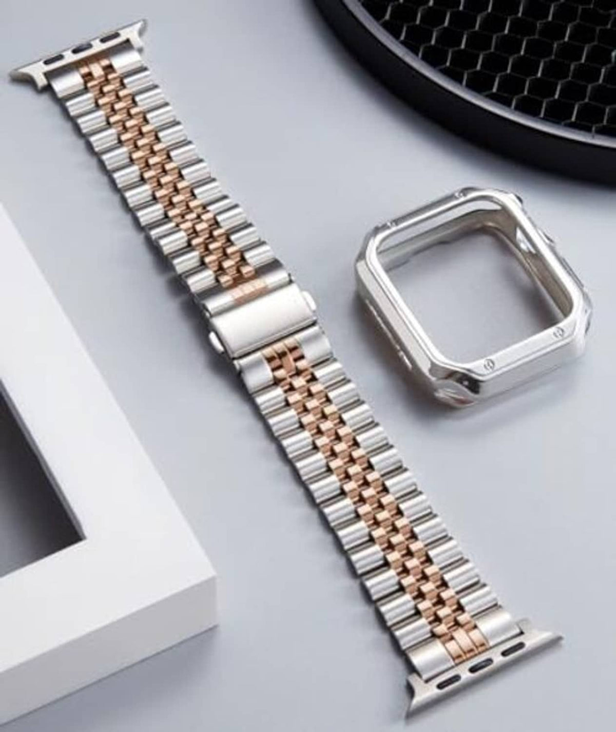 Silver and rose-gold metal link watch band with clasp