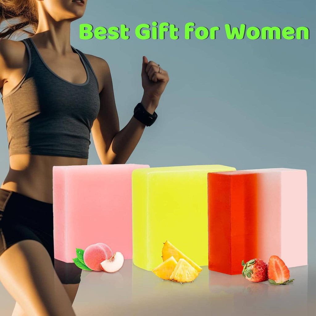 Three colorful handmade soap bars in pink, yellow, and orange with fruit on display
