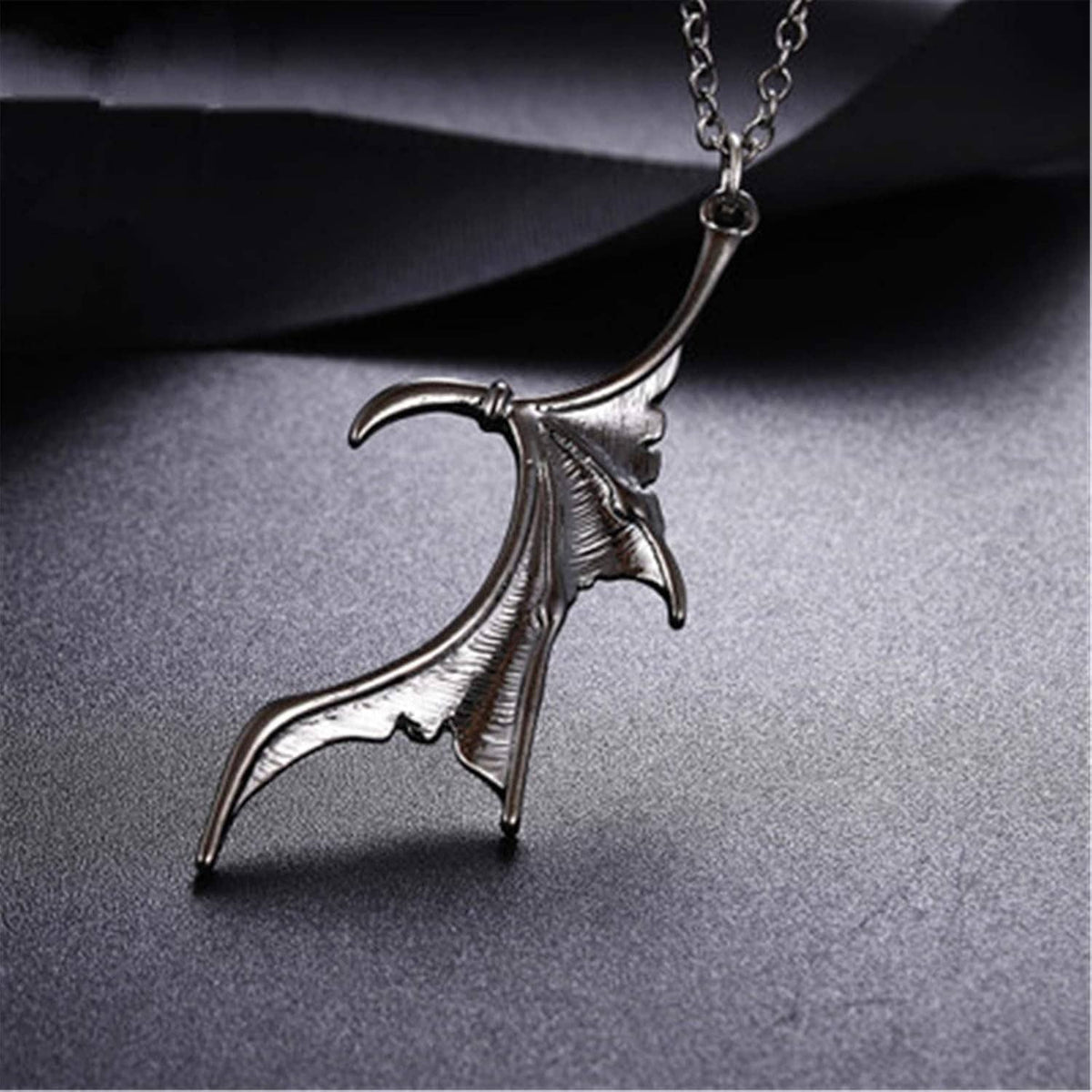 Silver bat-wing heart pendant on a chain necklace