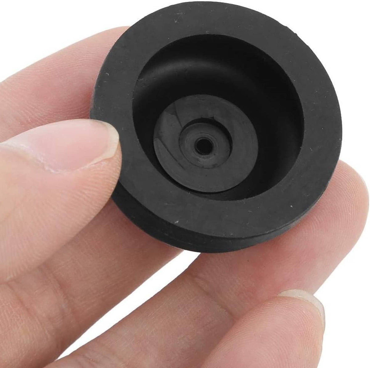 Close-up of a black rubber diaphragm with central hole and inner nozzle