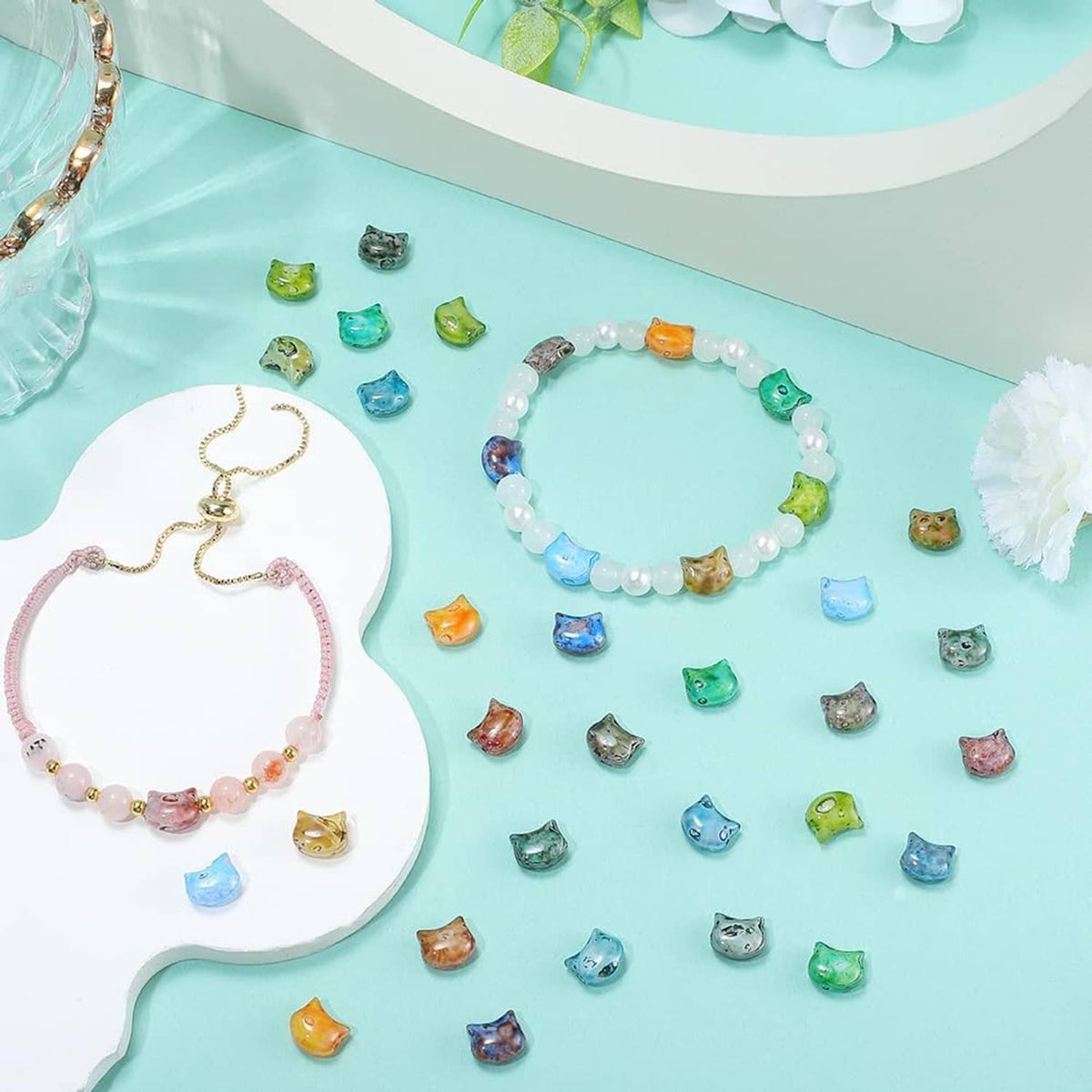 Cat-themed glass bead bracelet with small animal beads and a clasp.