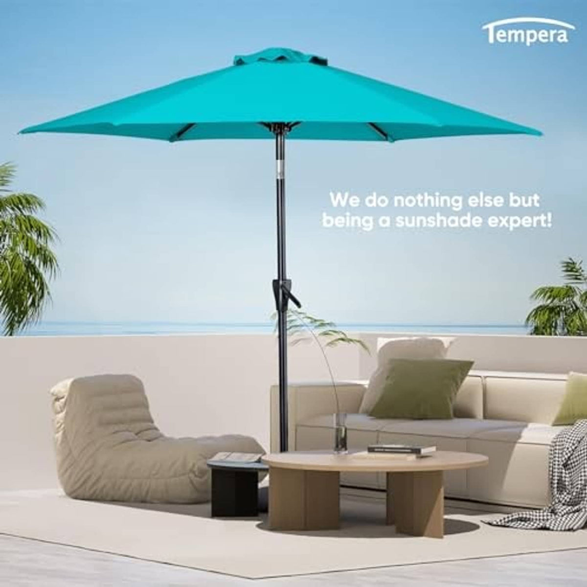 Turquoise outdoor table umbrella on pole with open canopy above patio seating