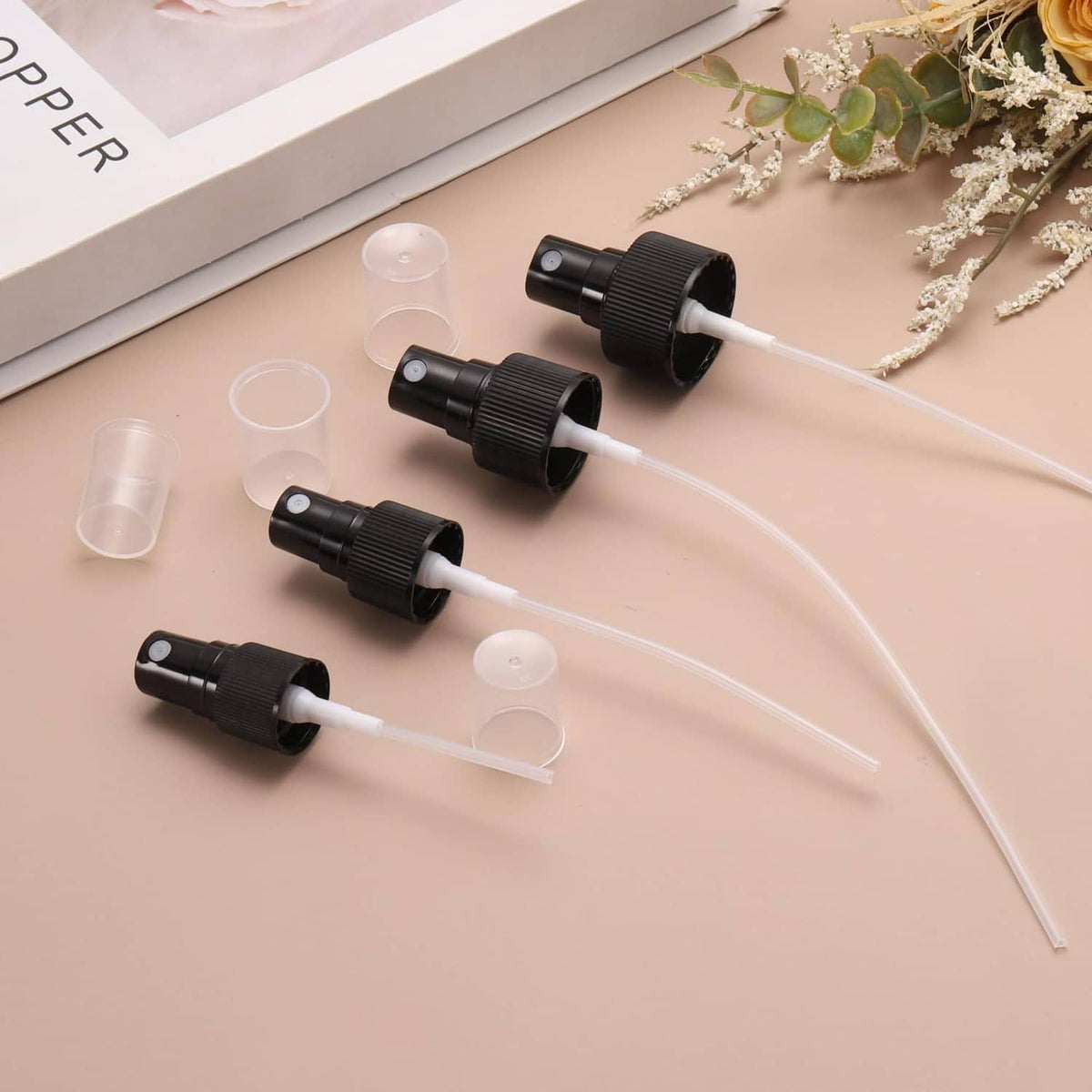 Black spray tops with long clear siphon tubes and removable plastic caps