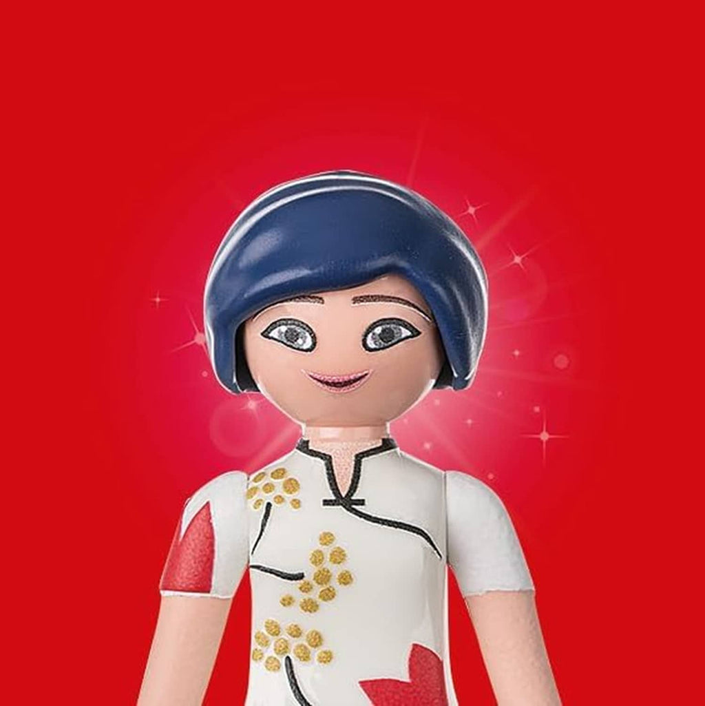 Chef doll figure with navy hat and white shirt with red sleeves, smiling