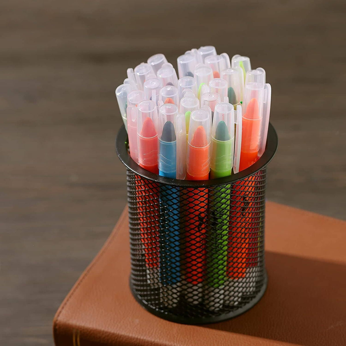Assorted gel highlighters standing in a metal cup, twist-up tips, bright colors