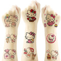 Child hands with Hello Kitty temporary tattoos, colorful cartoon character designs.