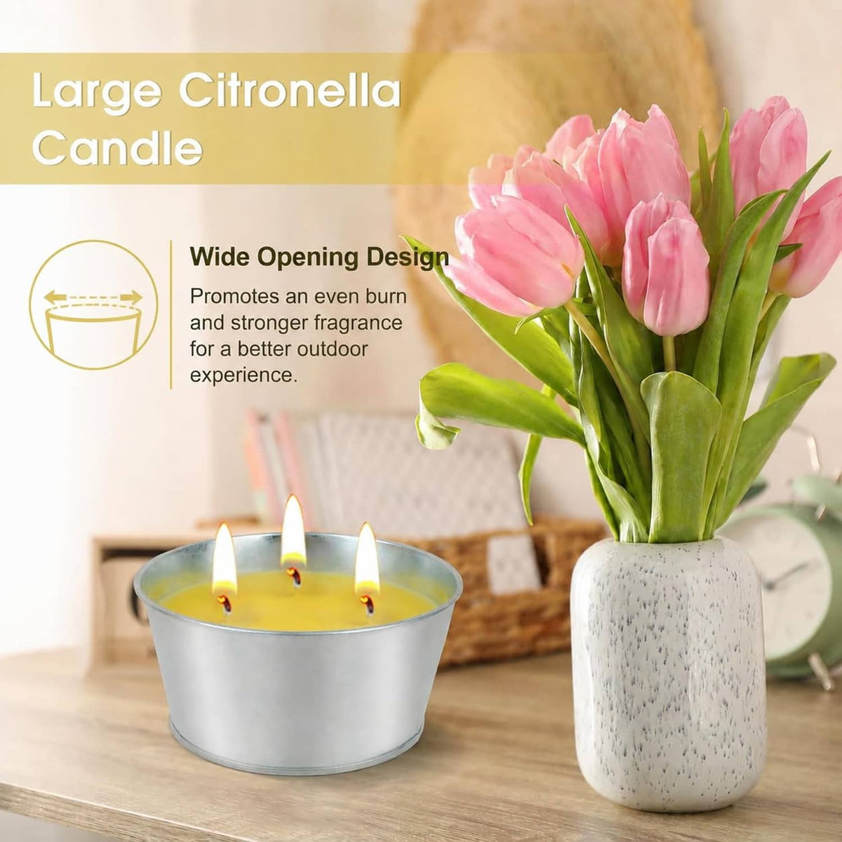 Large citronella candle in silver tin with three lit wicks on wooden surface