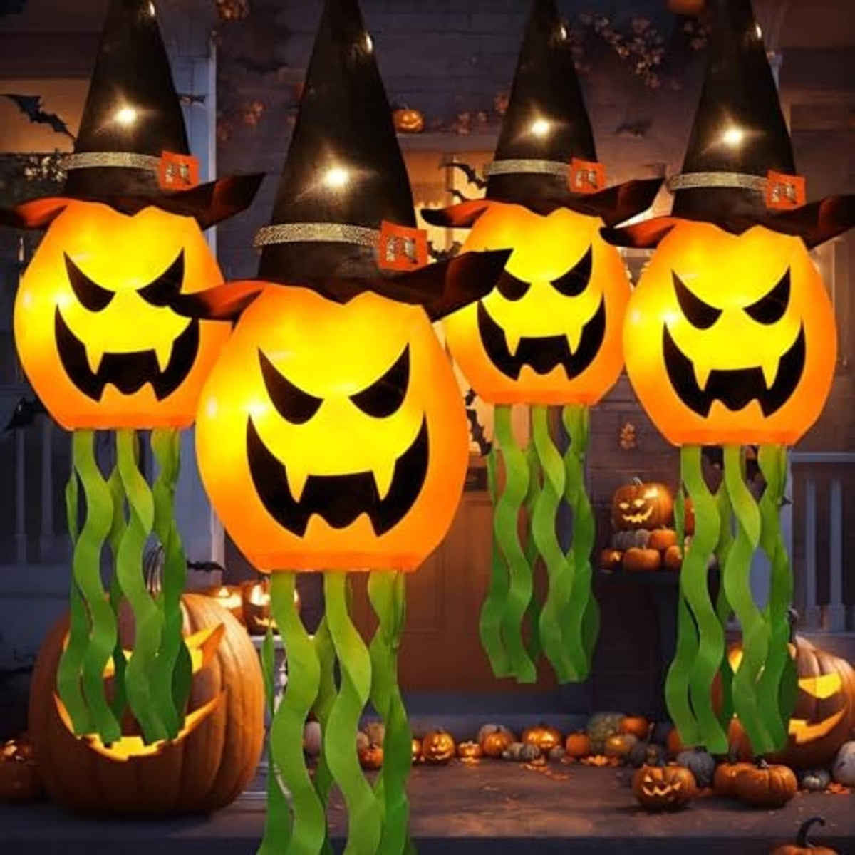 Multiple glowing jack-o’-lantern witch-hat hanging lights with green tentacles