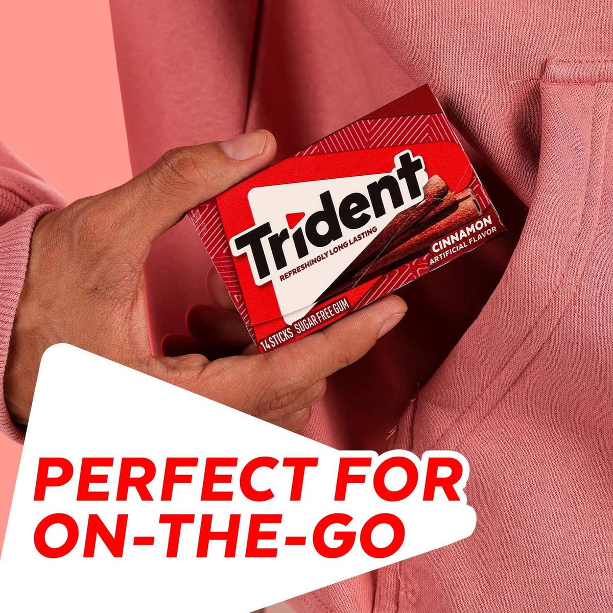 Trident cinnamon sugar-free gum pack held in hand, red and white package