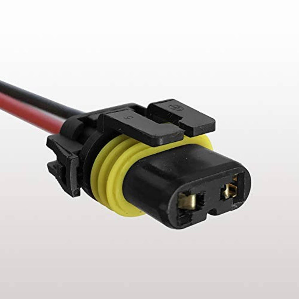 Close-up of female headlight wiring plug with black housing and yellow inner contacts