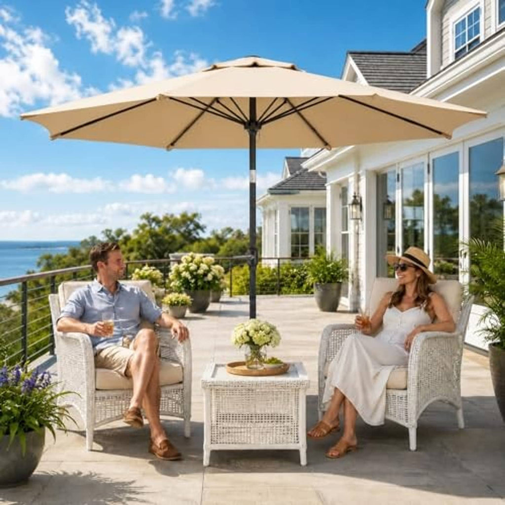 Beige patio umbrella over outdoor seating with chairs and table
