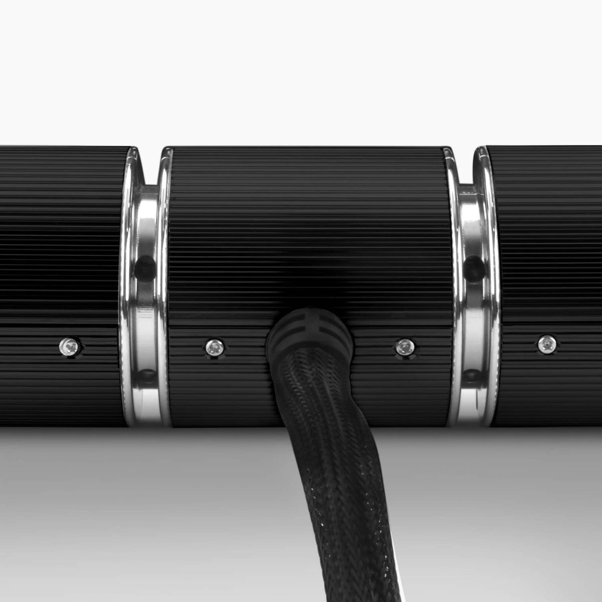 Close-up of two-piece speaker end caps with black cable/strap between chrome rings