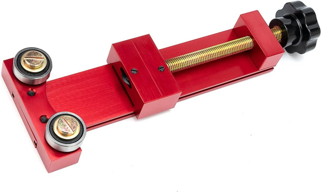Red oil filter cutter tool with threaded screw, two bearings, and black handle knob