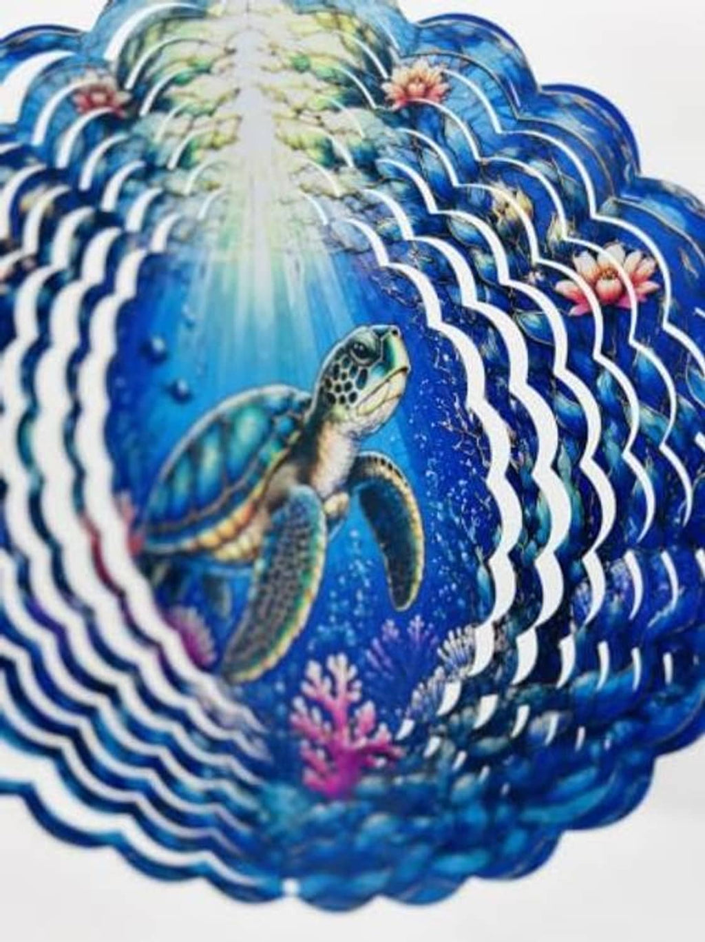 Turtle and coral accents on blue wind spinner with dense layered scallop pattern