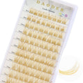 Gold-brown D-curl false lash clusters on clear tray, mixed lengths and clear bases
