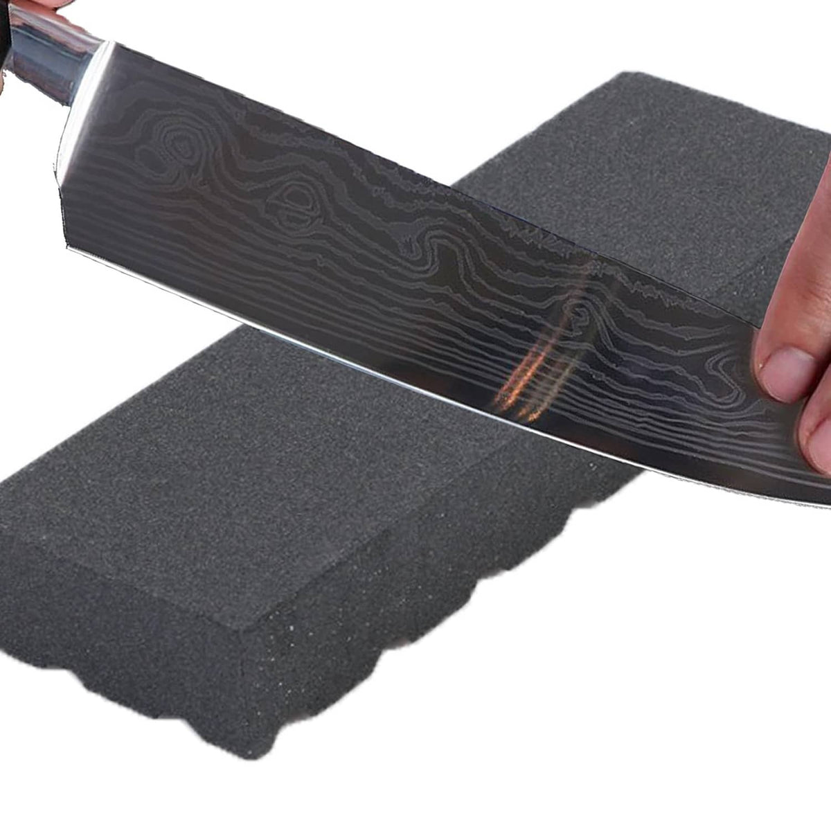 Black grooved whetstone sharpening a blade edge