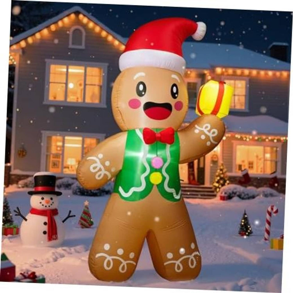 Close view of gingerbread man inflatable in red Santa hat and green icing, holding yellow gift