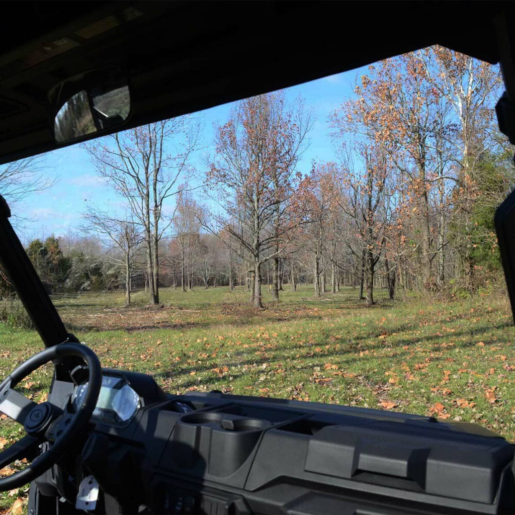 Polaris UTV cabin view showing full-size windshield edge and mounting frame