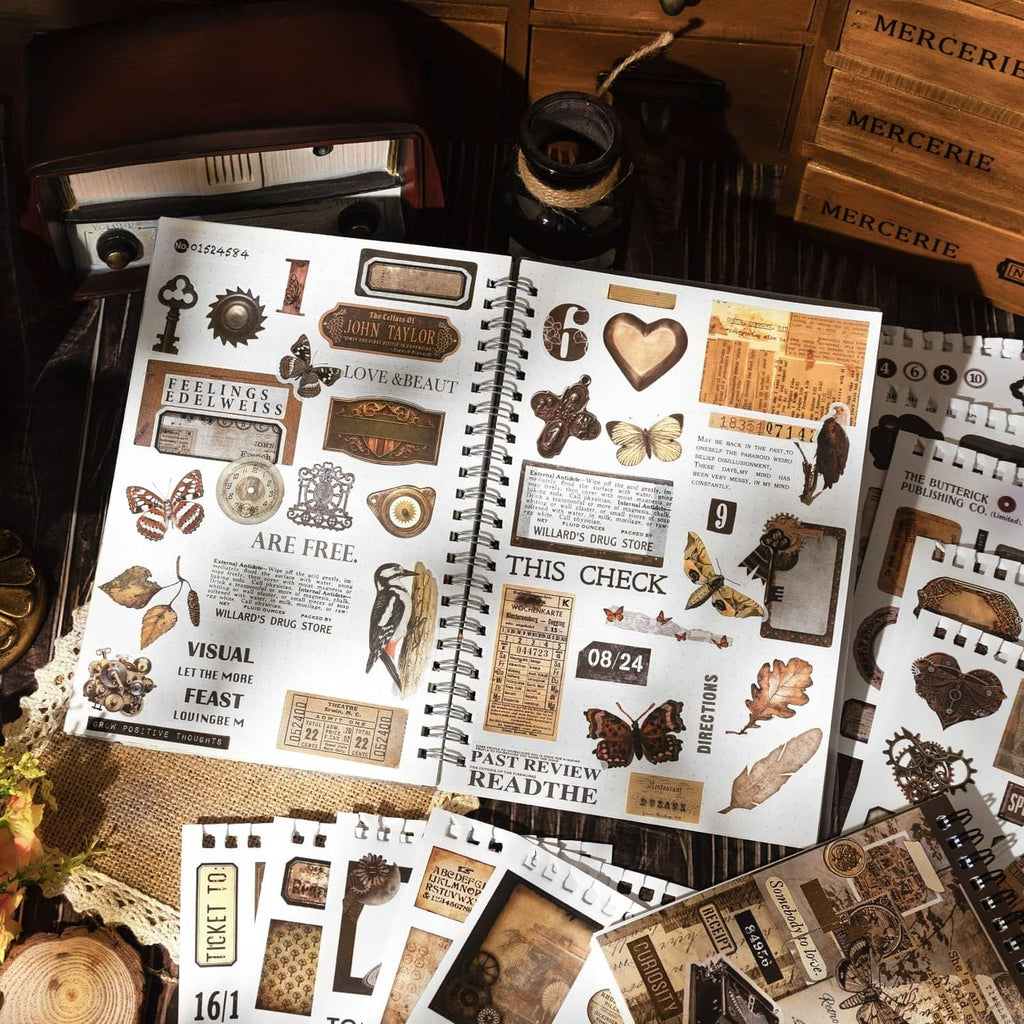 Vintage-style washi sticker sheets with hearts, tickets, clocks, and butterflies in a notebook