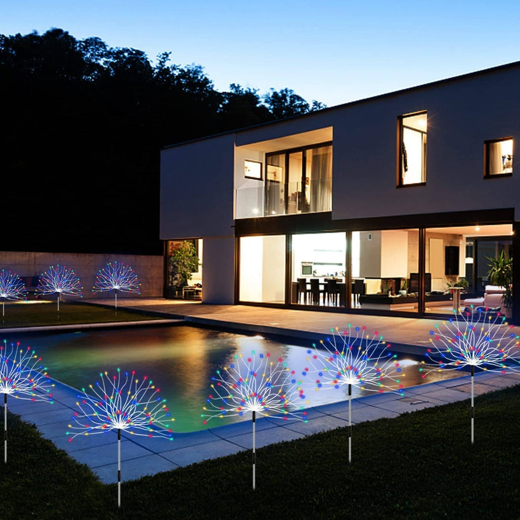 Solar RGB firework lights with glowing bursts along a patio walkway and lawn