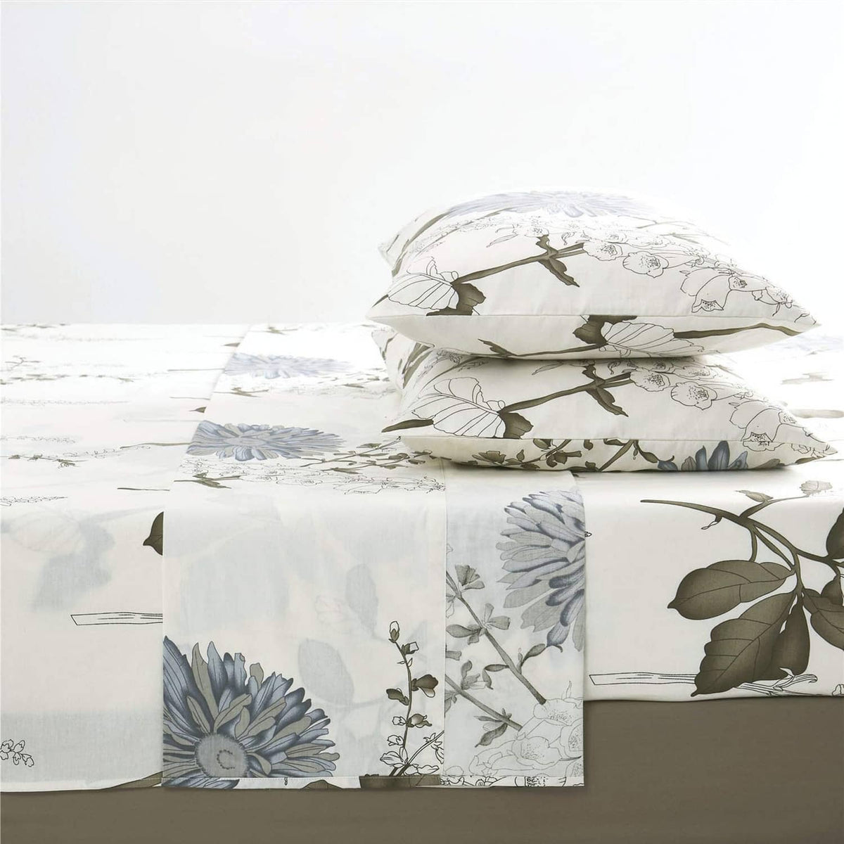 White bed sheet set with pillowcases and blue floral botanical pattern