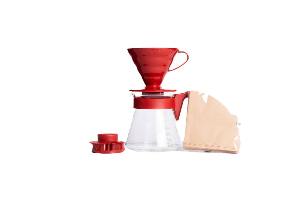 Red pour-over coffee dripper with glass carafe and red filter holder