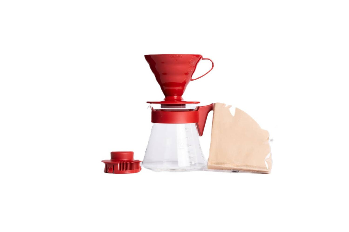 Red pour-over coffee dripper with glass carafe and red filter holder