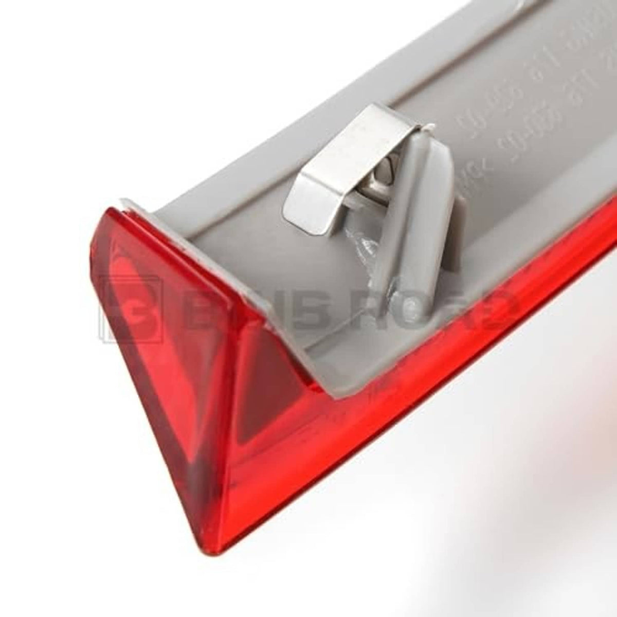 Red rear bumper reflector corner with visible mounting clip and gray mounting backing.