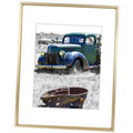 Gold picture frame with white mat, displaying a car print photo